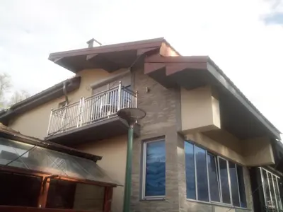 a house with a balcony and a street light at Lela in Jošanička Banja
