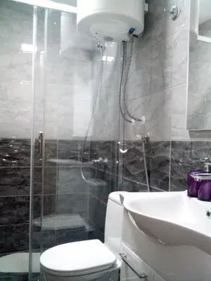 a bathroom with a shower and a toilet and a sink at Lela in Jošanička Banja