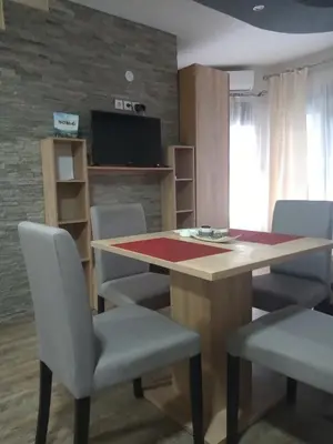 a dining room with a table and chairs at Lela in Jošanička Banja