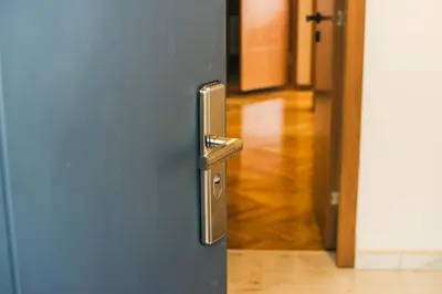 a door with a metal handle and a hallway at Aparment Theatre in Niš