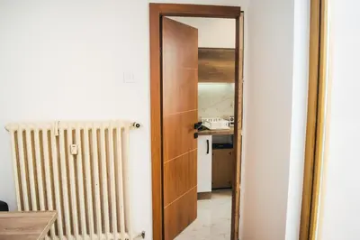 a hallway with a door leading to a kitchen at Aparment Theatre in Niš