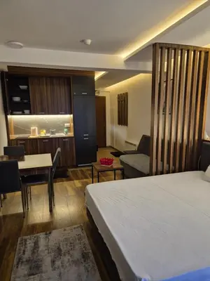 a hotel room with a bed and a dining room at President Kop S9, S3 & A103 in Kopaonik