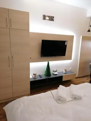 a bedroom with a bed with a television and a christmas tree at President Kop S9, S3 & A103 in Kopaonik