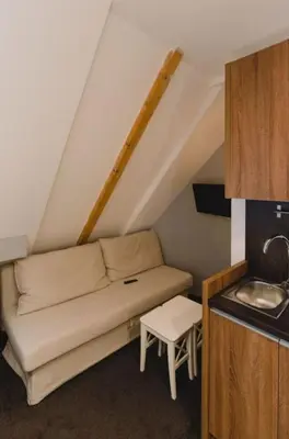 a couch in a small room with a sink at Mali Medved Konaci in Kopaonik