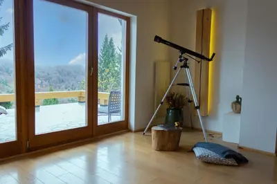 a camera on a tripod in a room with a window at 4Badgers / 4Jazavca - Mountain House in Kopaonik