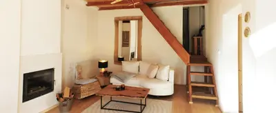 a living room with a white couch and a fireplace at 4Badgers / 4Jazavca - Mountain House in Kopaonik