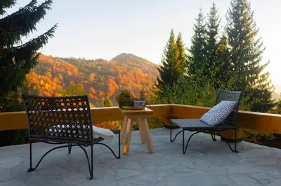 two chairs and a table on a patio with a view at 4Badgers / 4Jazavca - Mountain House in Kopaonik