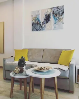 a living room with a couch and two tables at P20 Milmari, DeLuxe Studio, Kopaonik in Kopaonik