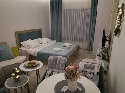 a small room with a bed and a couch and tables at P20 Milmari, DeLuxe Studio, Kopaonik in Kopaonik