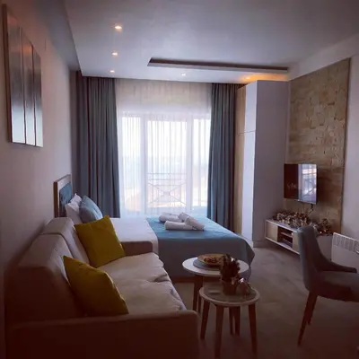 a hotel room with a bed and a couch at P20 Milmari, DeLuxe Studio, Kopaonik in Kopaonik