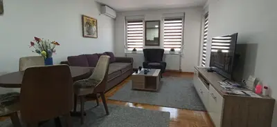 a living room with a couch and a tv at Apartman N&N in Vrnjačka Banja