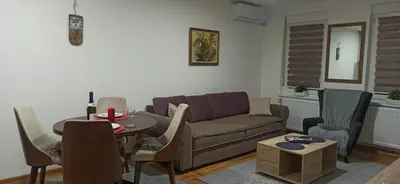 a living room with a couch and a table at Apartman N&N in Vrnjačka Banja