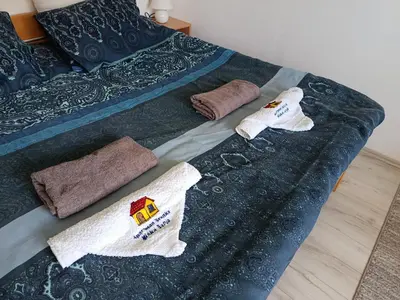 a bed with towels and pillows on it at Apartman Branka in Niška Banja