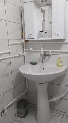 a bathroom with a white sink and a mirror at Apartman Branka in Niška Banja
