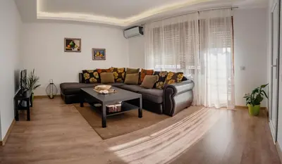 a living room with a couch and a table at Apartmani Jovčić in Leskovac