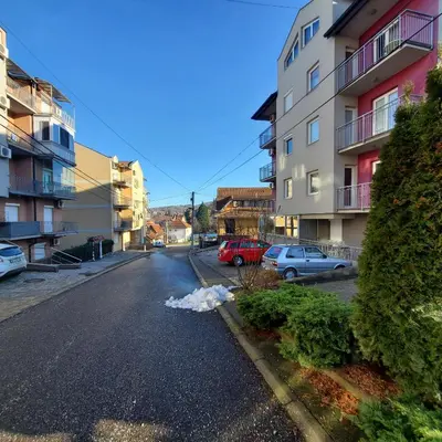 an empty street with cars parked on the side at Apartment Atria in Vrnjačka Banja
