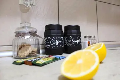 a counter with two bottles of coffee and a slice of lemon at Apartment Atria in Vrnjačka Banja