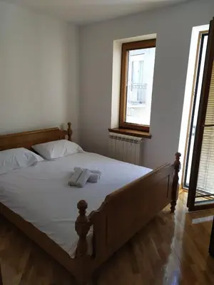 a bedroom with a bed with two towels on it at Apartman Miloš in Vrnjačka Banja