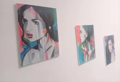 a group of paintings hanging on a wall at Apartman Miloš in Vrnjačka Banja