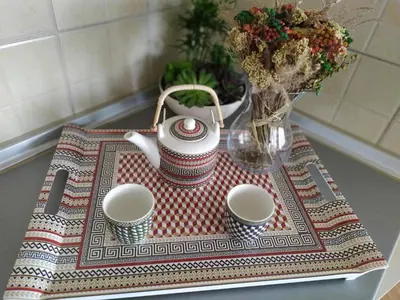 a tea kettle and two cups on a table at Apartman Miloš in Vrnjačka Banja