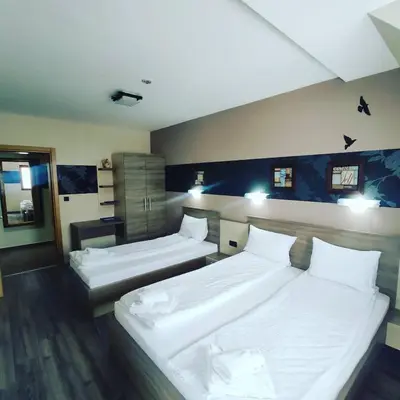 two beds in a hotel room with two beds sidx sidx sidx at Apartman D16 Milmari Kopaonik in Kopaonik