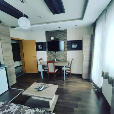 a living room with a table and a dining room at Apartman D16 Milmari Kopaonik in Kopaonik