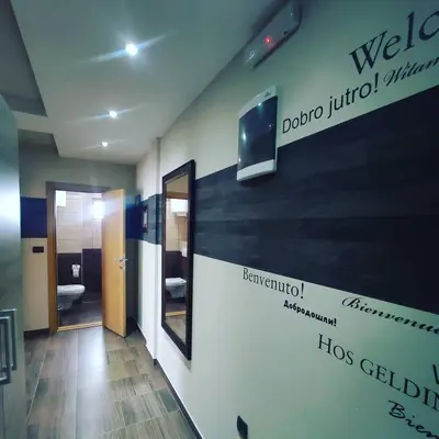a bathroom with a wall with a sign on it at Apartman D16 Milmari Kopaonik in Kopaonik