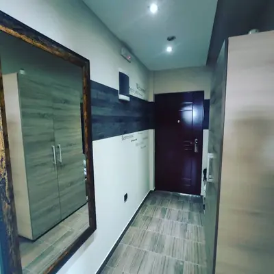 a mirror on the wall of a hallway with a door at Apartman D16 Milmari Kopaonik in Kopaonik