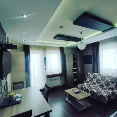 a living room with a couch and a table at Apartman D16 Milmari Kopaonik in Kopaonik