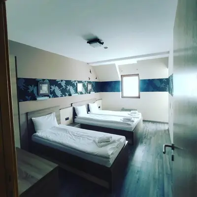 a room with two beds in a room at Apartman D16 Milmari Kopaonik in Kopaonik