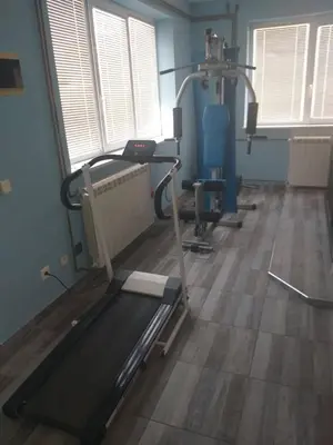 a room with a gym with a treadmill and tread machines at Lux Apartmani Nikola in Vrnjačka Banja