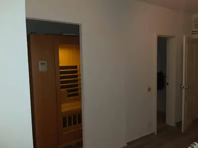 a hallway with a mirror and a room with a closet at Lux Apartmani Nikola in Vrnjačka Banja