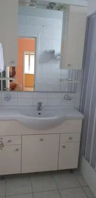 a bathroom with a sink and a mirror at Lux Apartmani Nikola in Vrnjačka Banja