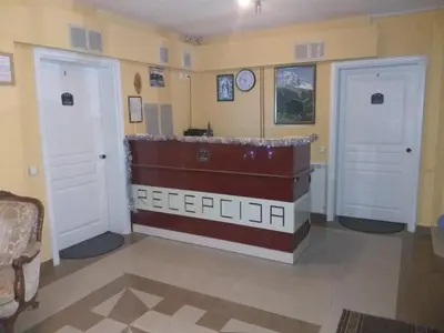 a room with two doors and a clock on the wall at Lux Apartmani Nikola in Vrnjačka Banja