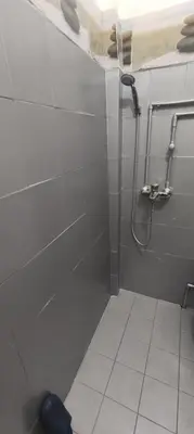 a bathroom with a shower with a tiled floor at Apartman Jasna, in Pirot