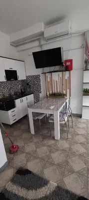 a kitchen with a table and chairs in a room at Apartman Jasna, in Pirot