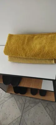 a yellow rug sitting on top of a white table at Apartman Jasna, in Pirot