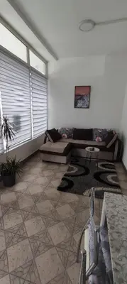 a living room with a couch and a table at Apartman Jasna, in Pirot