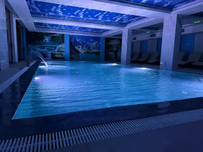 a swimming pool in a hotel at night at Grand Elegant & Spa Kop in Kopaonik