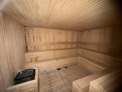 a large empty sauna with a wooden floor and ceiling at Grand Elegant & Spa Kop in Kopaonik