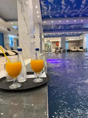 two glasses of orange juice on a tray in a lobby at Grand Elegant & Spa Kop in Kopaonik