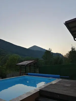 a swimming pool with a view of the mountains at Vikendica Lep pogled in Rtanj