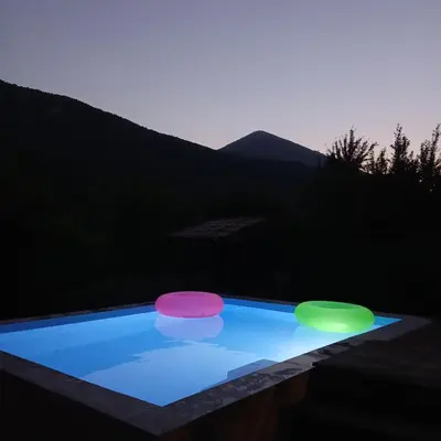 two frisbees in a swimming pool at night at Vikendica Lep pogled in Rtanj