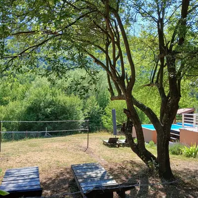a park with a tree and a picnic table at Vikendica Lep pogled in Rtanj