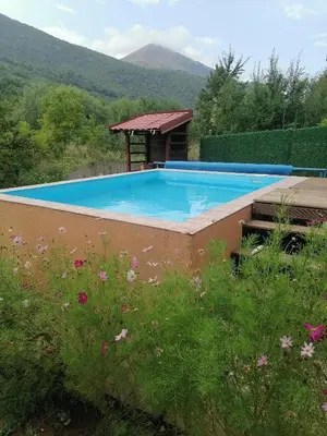 a large swimming pool with a gazebo at Vikendica Lep pogled in Rtanj