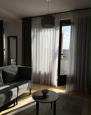 a living room with a couch and a table at MILA in Vrnjačka Banja