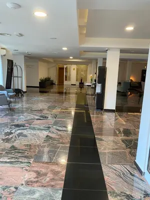 a lobby with a large floor with a long hallway at MILA in Vrnjačka Banja
