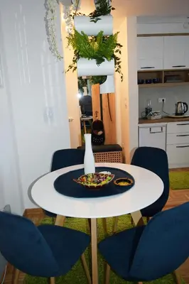 a white table with chairs and a plate on it at Apartman Safir in Vrnjačka Banja