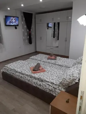 a bedroom with a large bed with towels on it at Stan KALA in Vrnjačka Banja