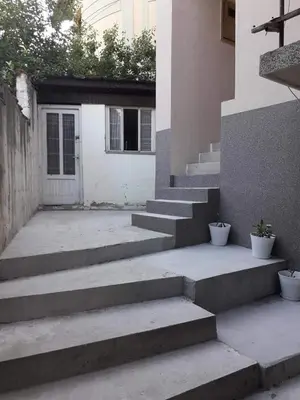 a set of concrete stairs leading to a garage at Stan KALA in Vrnjačka Banja